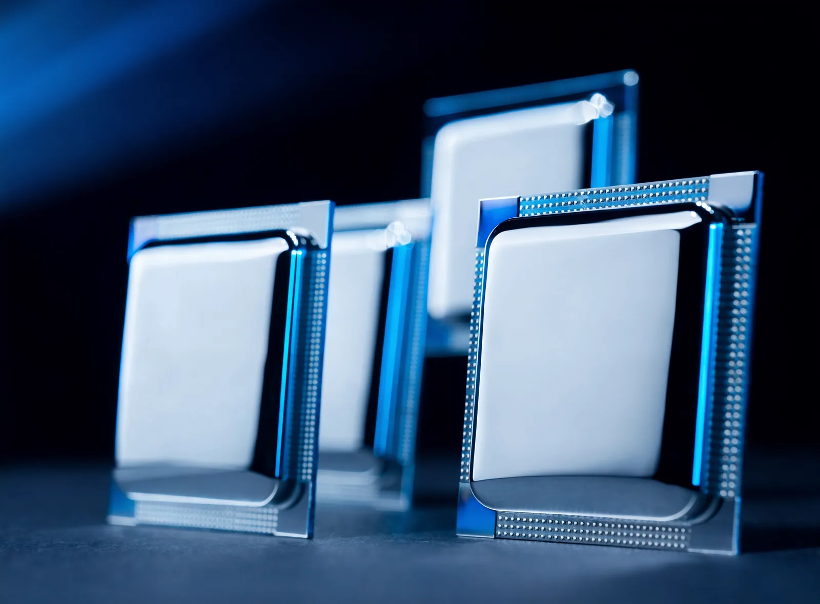 Server processors showing polished heat spreaders and gold LGA contact pads on a dark surface